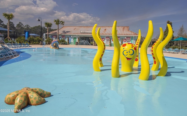 view of swimming pool featuring a water play area and a water slide