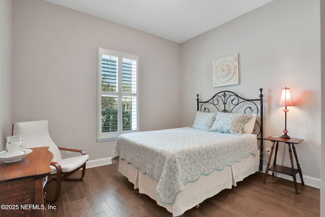 bedroom featuring dark wood-style floors and baseboards