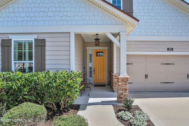 view of exterior entry with concrete driveway