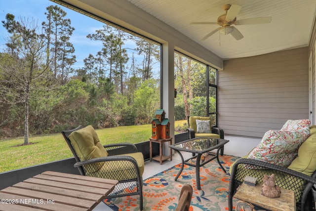 sunroom / solarium featuring ceiling fan