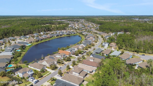 aerial view featuring a residential view, a water view, and a view of trees