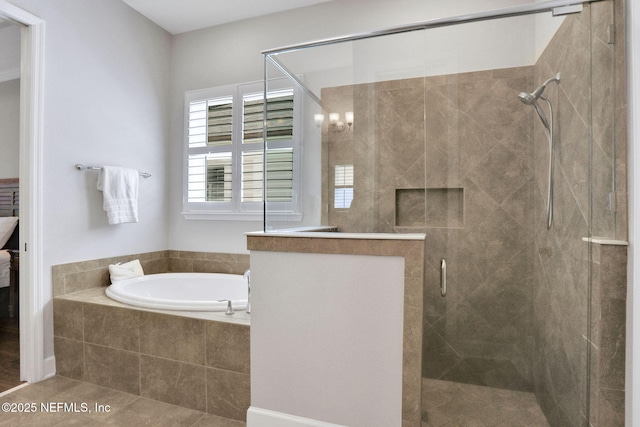 bathroom featuring a stall shower, ensuite bathroom, and a garden tub