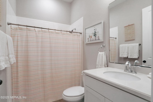 bathroom featuring vanity, a shower with shower curtain, and toilet