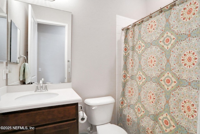 bathroom with a shower with shower curtain, toilet, and vanity