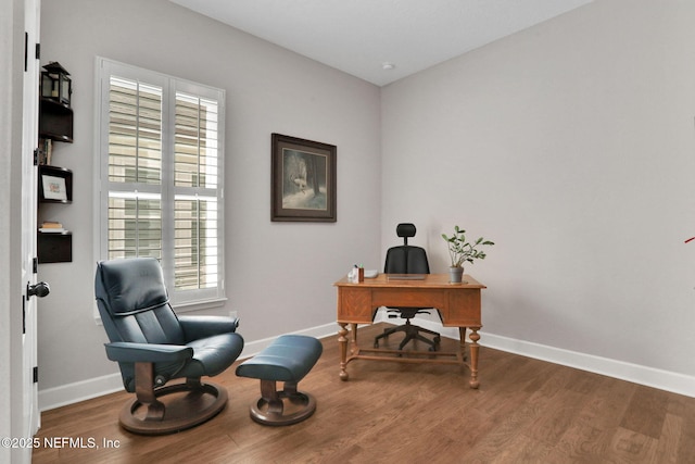 office space with wood finished floors and baseboards