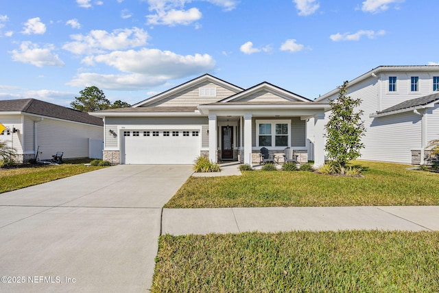 view of front of home with a garage, driveway, stone siding, a porch, and a front lawn