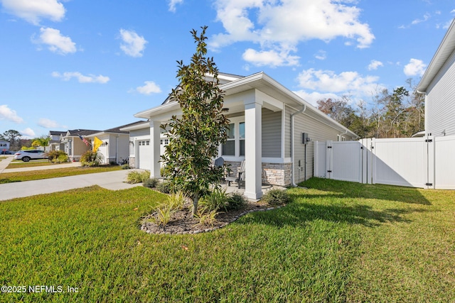 view of side of property featuring driveway, a garage, a gate, and a lawn