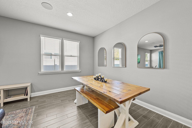 dining space featuring baseboards, a textured ceiling, recessed lighting, and wood tiled floor