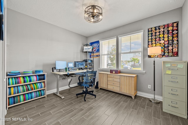 office with a notable chandelier, wood finish floors, and baseboards