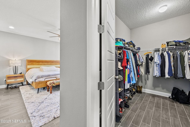 spacious closet featuring ceiling fan and wood tiled floor