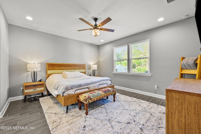 bedroom with wood tiled floor, ceiling fan, baseboards, and recessed lighting