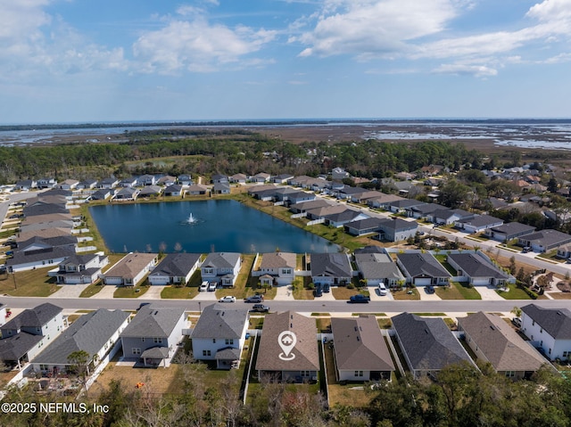 birds eye view of property featuring a water view and a residential view