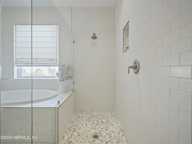 full bath featuring tiled shower and a bath