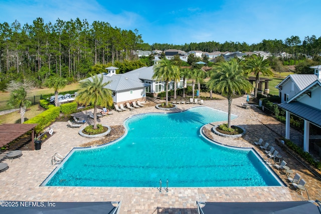 pool with a patio and fence