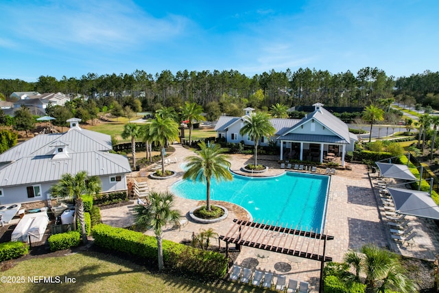 community pool featuring a patio area and fence