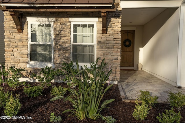 property entrance featuring stone siding