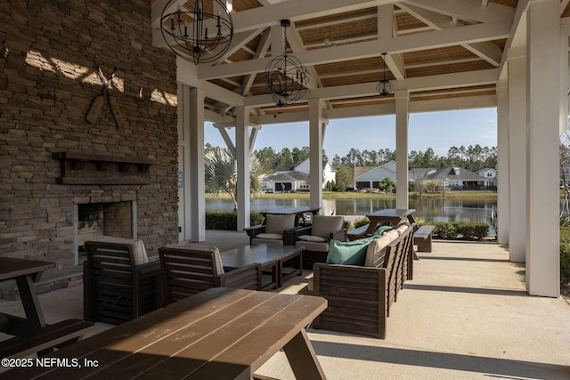 view of patio / terrace featuring outdoor dining area, a water view, a gazebo, an outdoor hangout area, and a residential view