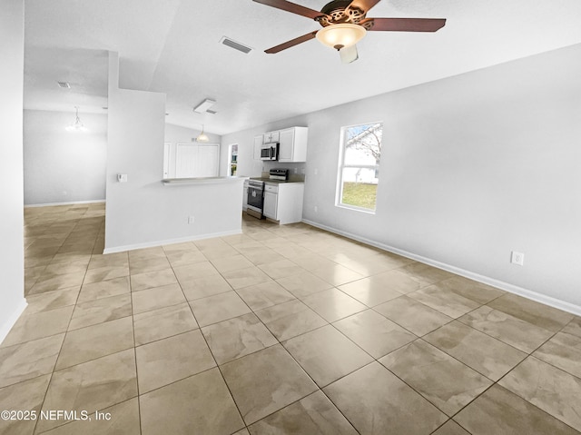 unfurnished living room with vaulted ceiling, light tile patterned floors, visible vents, and a ceiling fan