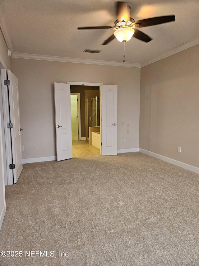 unfurnished bedroom featuring visible vents, ornamental molding, a textured ceiling, and light colored carpet