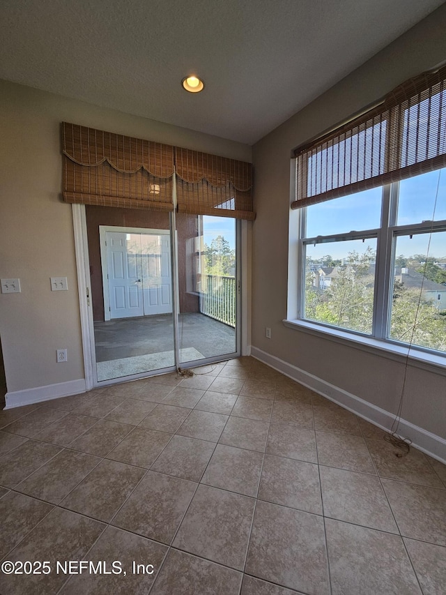 spare room with tile patterned flooring, baseboards, and recessed lighting