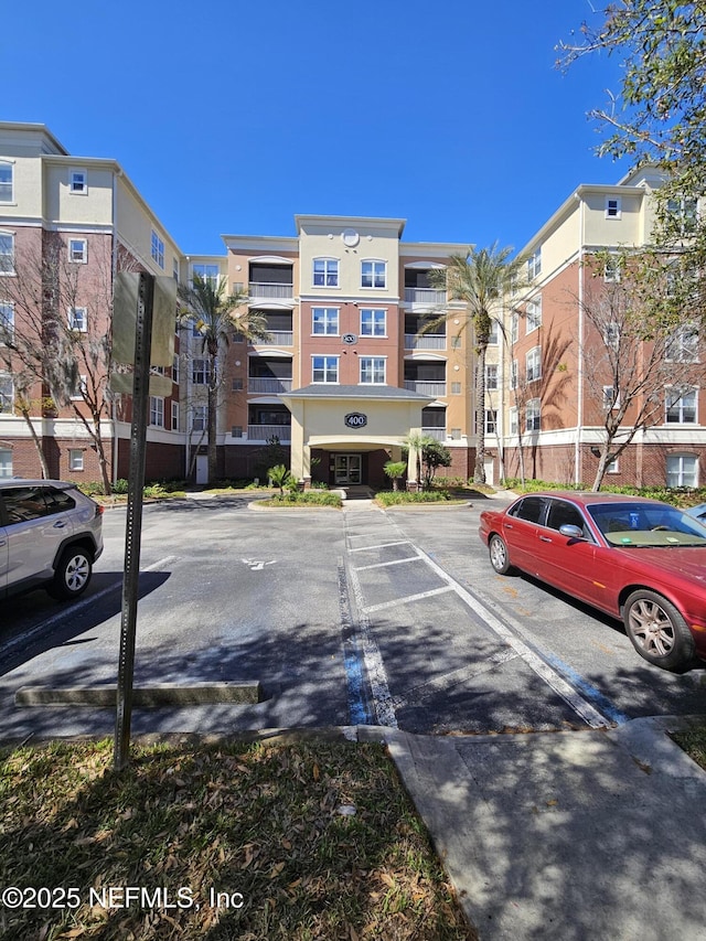 view of property featuring uncovered parking