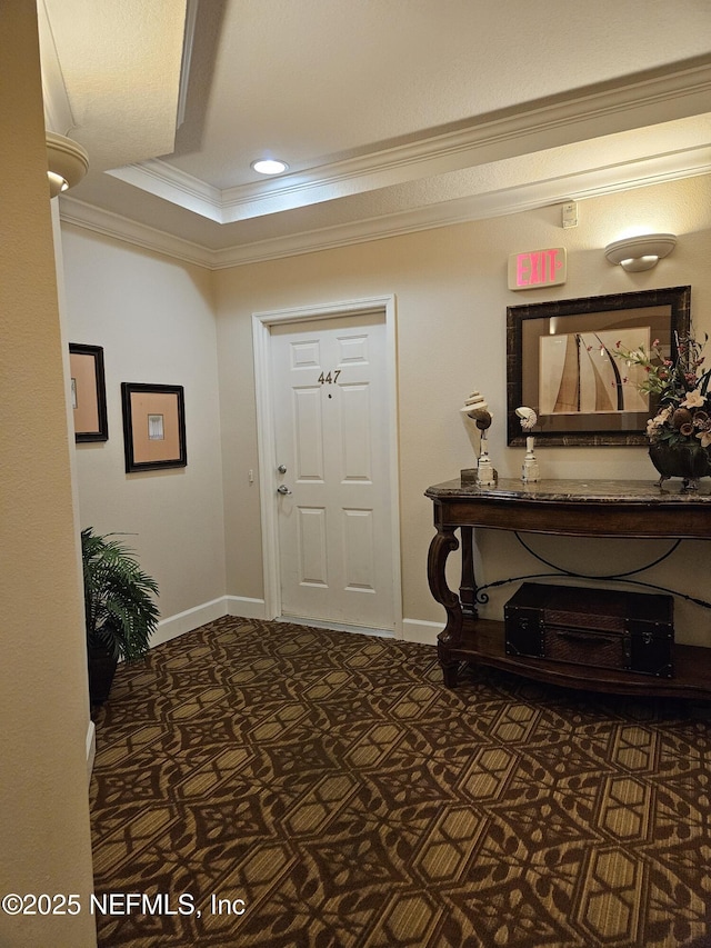 foyer entrance with baseboards, ornamental molding, dark carpet, and recessed lighting