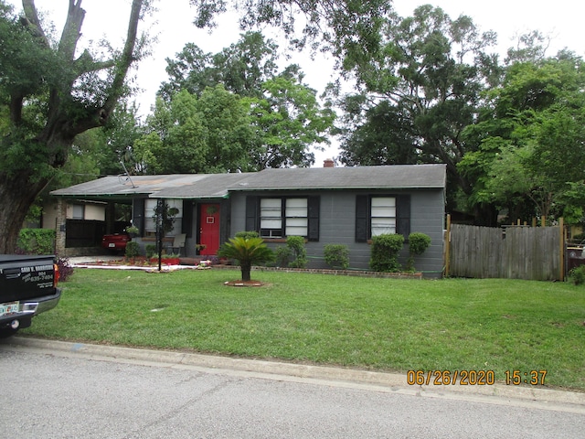 view of front of home with a front lawn and fence