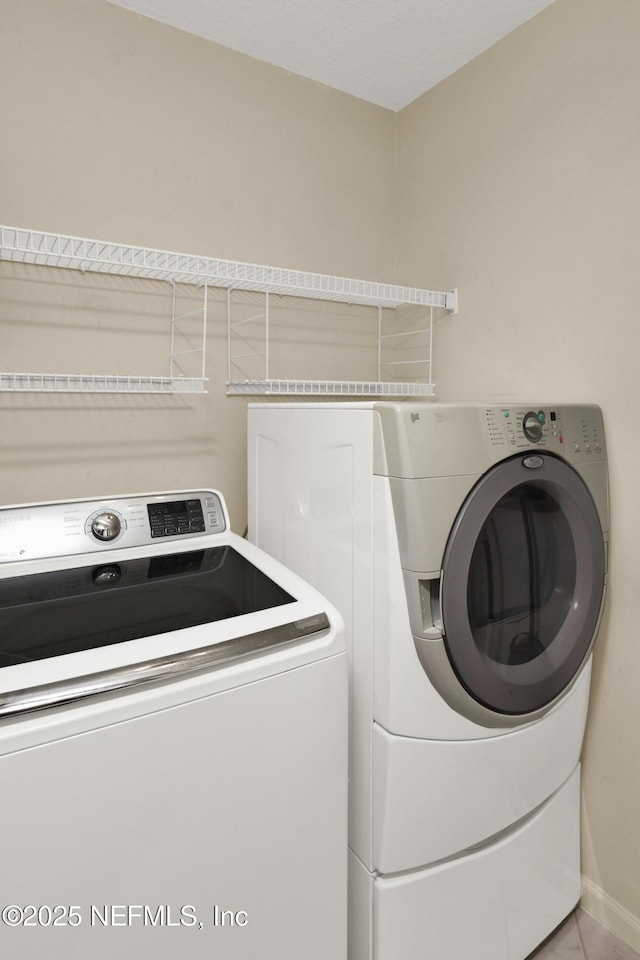 clothes washing area with laundry area and washing machine and clothes dryer