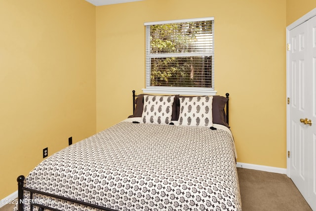 carpeted bedroom featuring baseboards