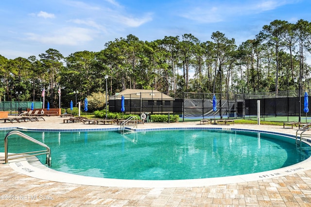 pool featuring a patio and fence