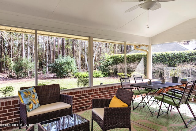 sunroom / solarium with a ceiling fan and vaulted ceiling