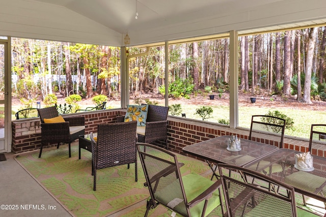 sunroom featuring lofted ceiling