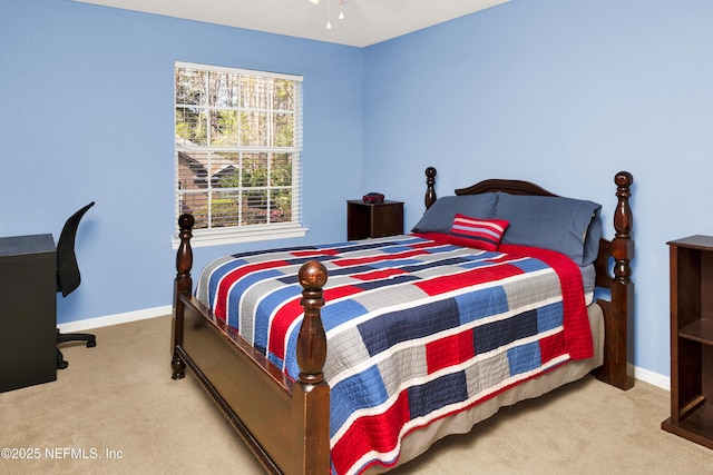 carpeted bedroom featuring ceiling fan and baseboards