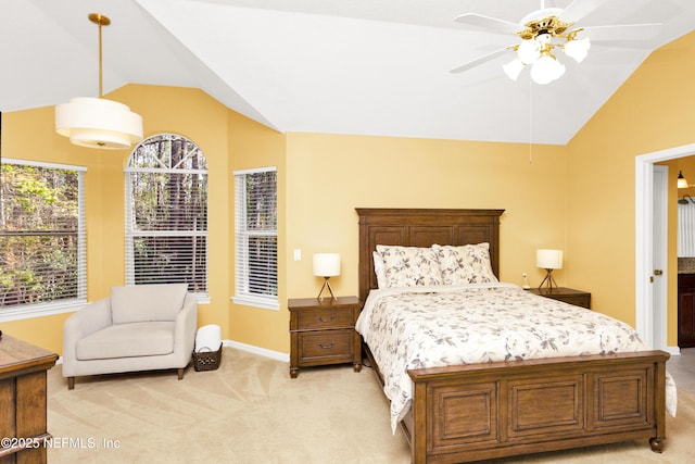 bedroom with light colored carpet, vaulted ceiling, and baseboards