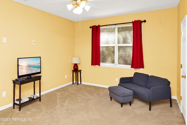 sitting room featuring ceiling fan, baseboards, and carpet flooring