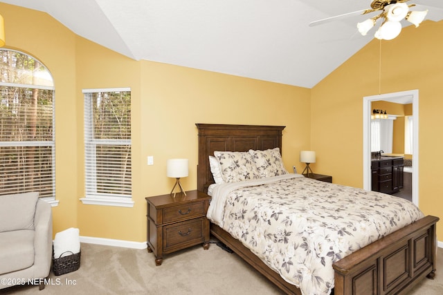 bedroom with light carpet, vaulted ceiling, baseboards, and ceiling fan