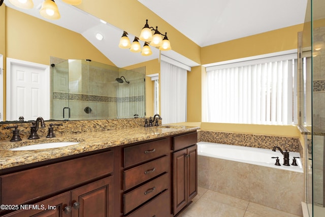 full bath with a stall shower, a sink, lofted ceiling, and tile patterned floors