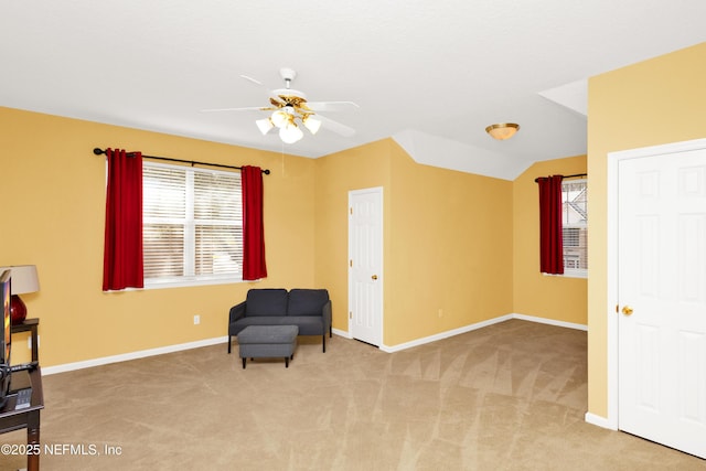 sitting room featuring a wealth of natural light, baseboards, and carpet flooring