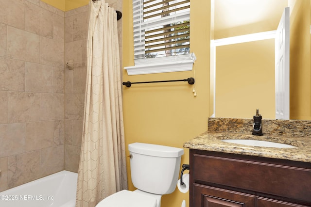 full bath featuring toilet, shower / bath combo with shower curtain, and vanity