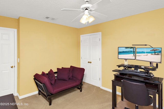 office area featuring baseboards, carpet, visible vents, and a ceiling fan