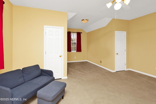 living area with lofted ceiling, carpet flooring, and baseboards