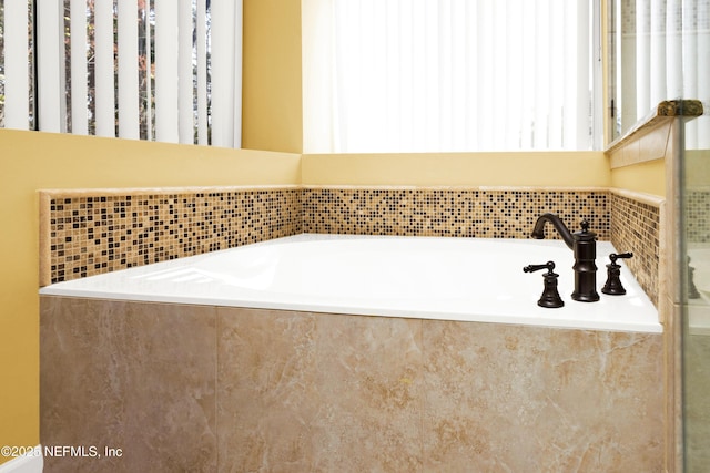 bathroom with a garden tub