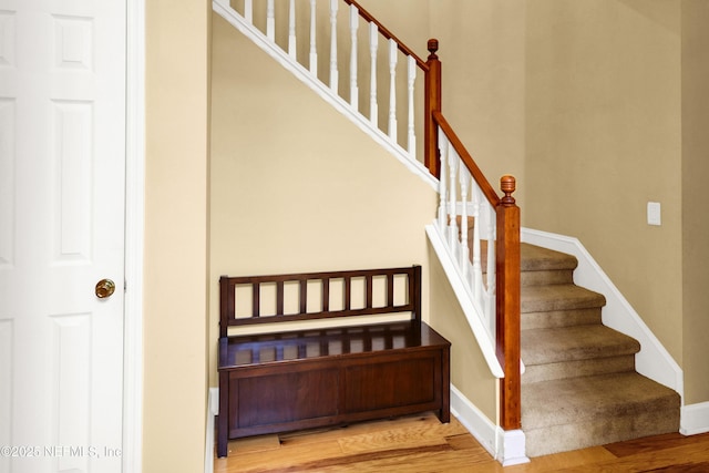 stairs with baseboards and wood finished floors