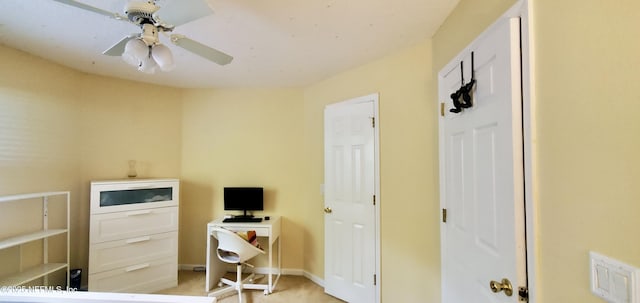 office area with ceiling fan and baseboards