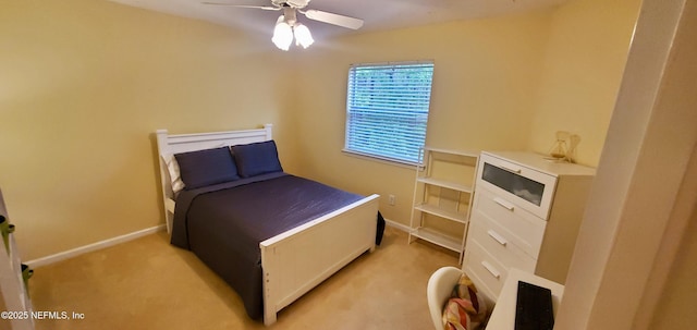 bedroom with baseboards, a ceiling fan, and light colored carpet