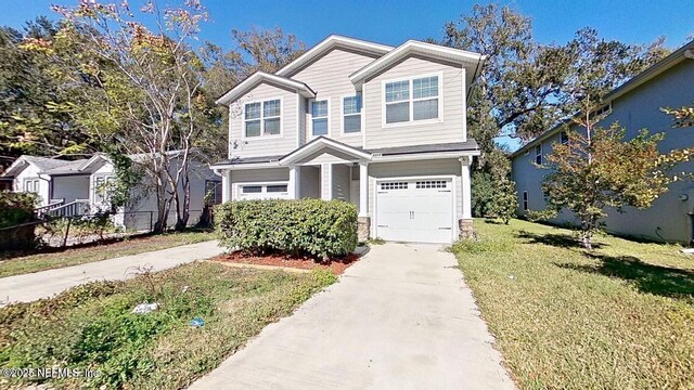 view of front of house featuring a garage, driveway, a front yard, and fence