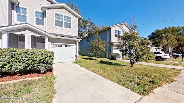 view of front of home with driveway, a garage, and a front yard