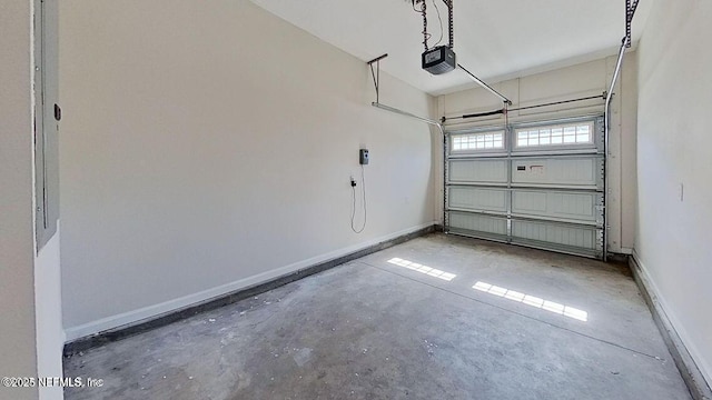 garage with baseboards and a garage door opener