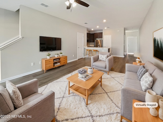 living area featuring recessed lighting, wood finished floors, a ceiling fan, baseboards, and visible vents