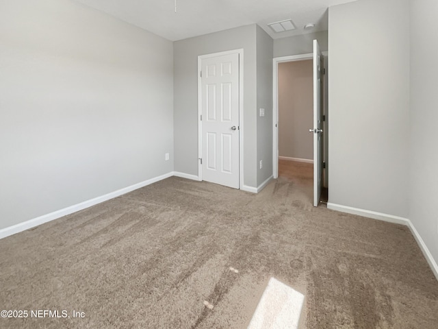 unfurnished bedroom featuring carpet floors and baseboards